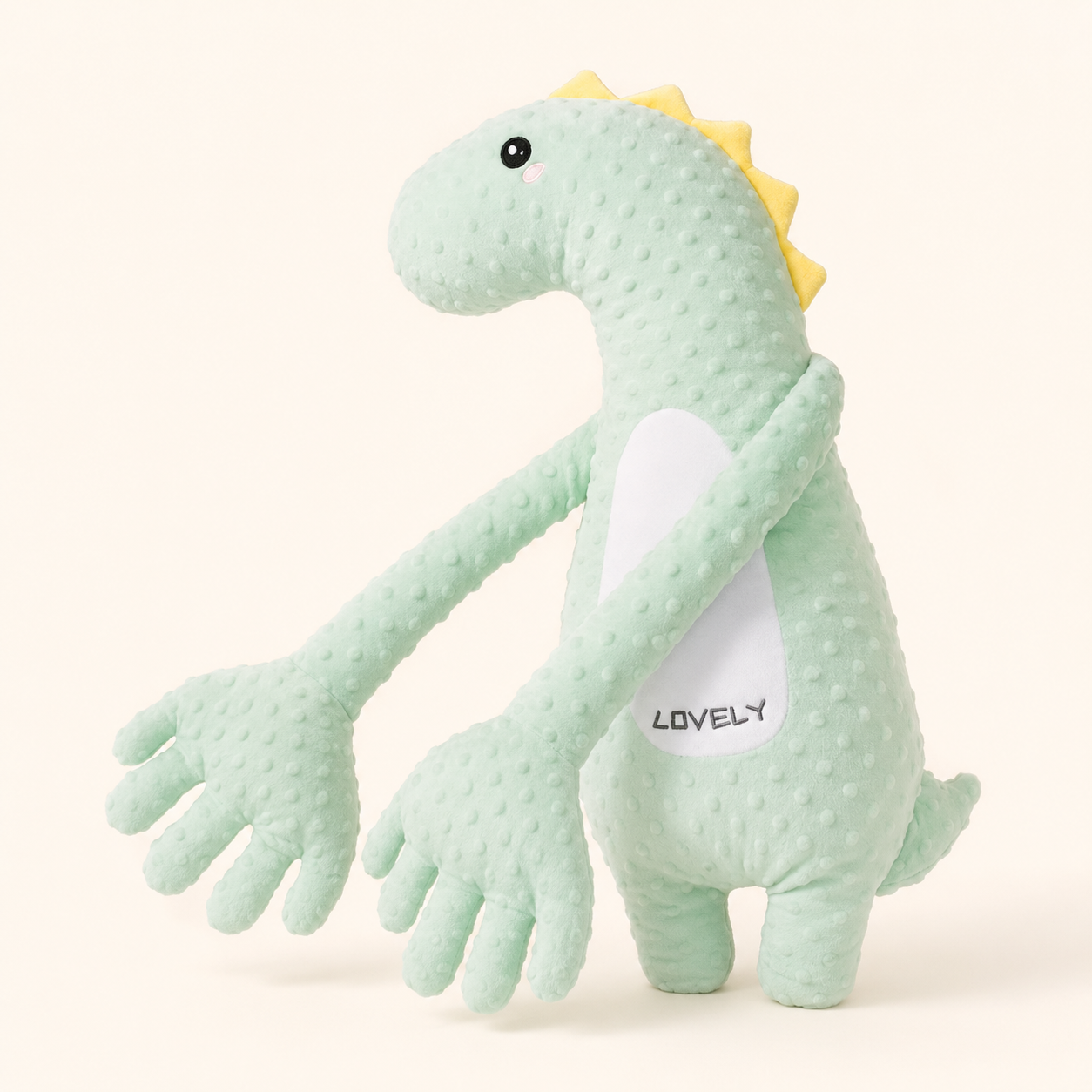 Dino Cocolinoo, peluche dinosaure vert menthe à longues pattes sur fond crème